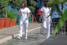 Two attractive Filipina nurses give particular care to fortunate male vacationer